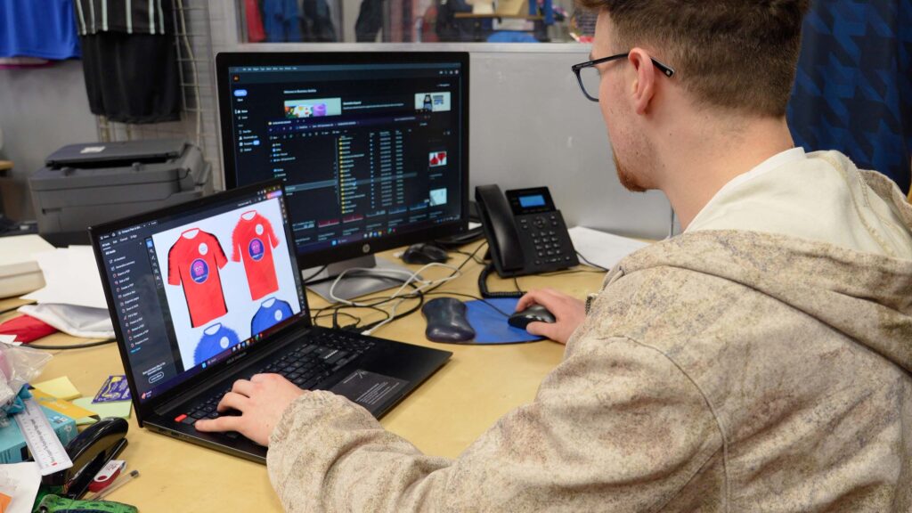 Creative Lead going through football kit designs with customer